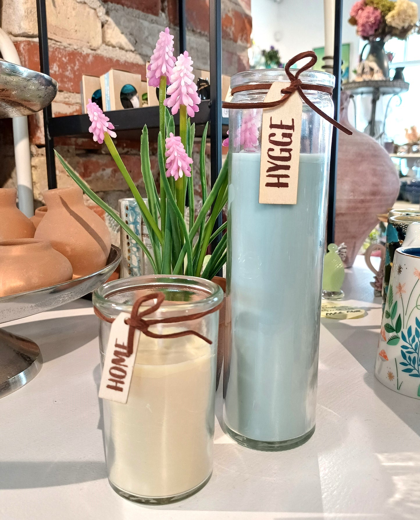 "Hygge" lyseblå stearinlys i glas.