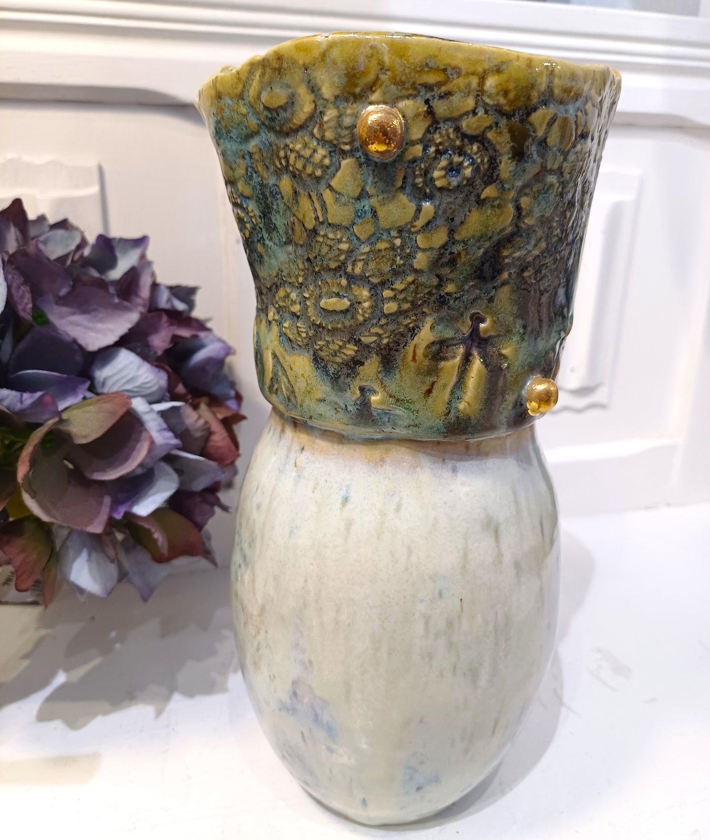 Marmoret vase med guld knopper.