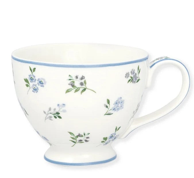 Te kop med små blå blomster.